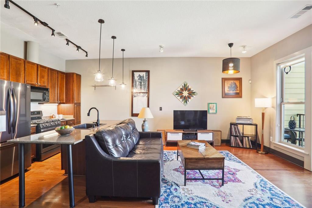 a living room with fireplace furniture and a flat screen tv