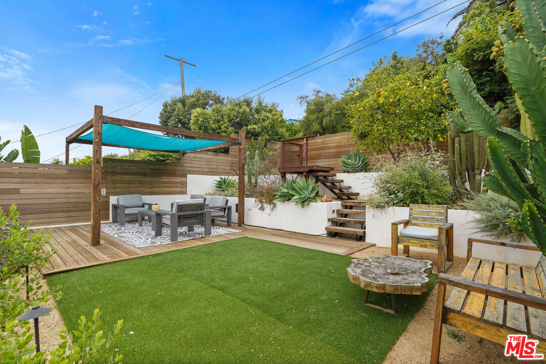 a view of a backyard with sitting area