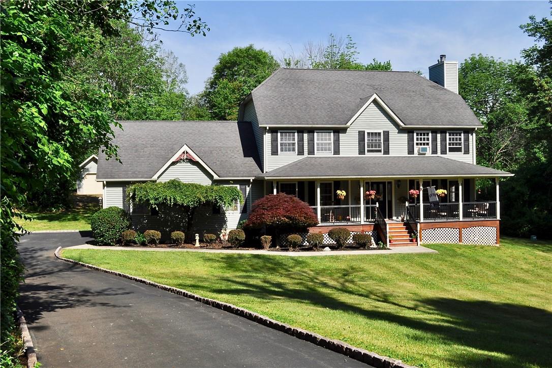 Colonial inspired home featuring a Manicured landscaping.