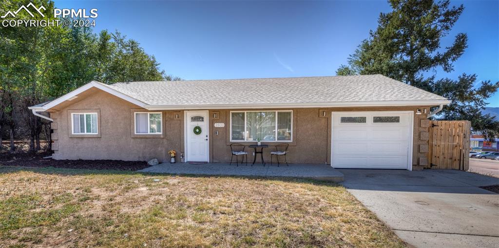 Ranch-style home with a front yard and a garage