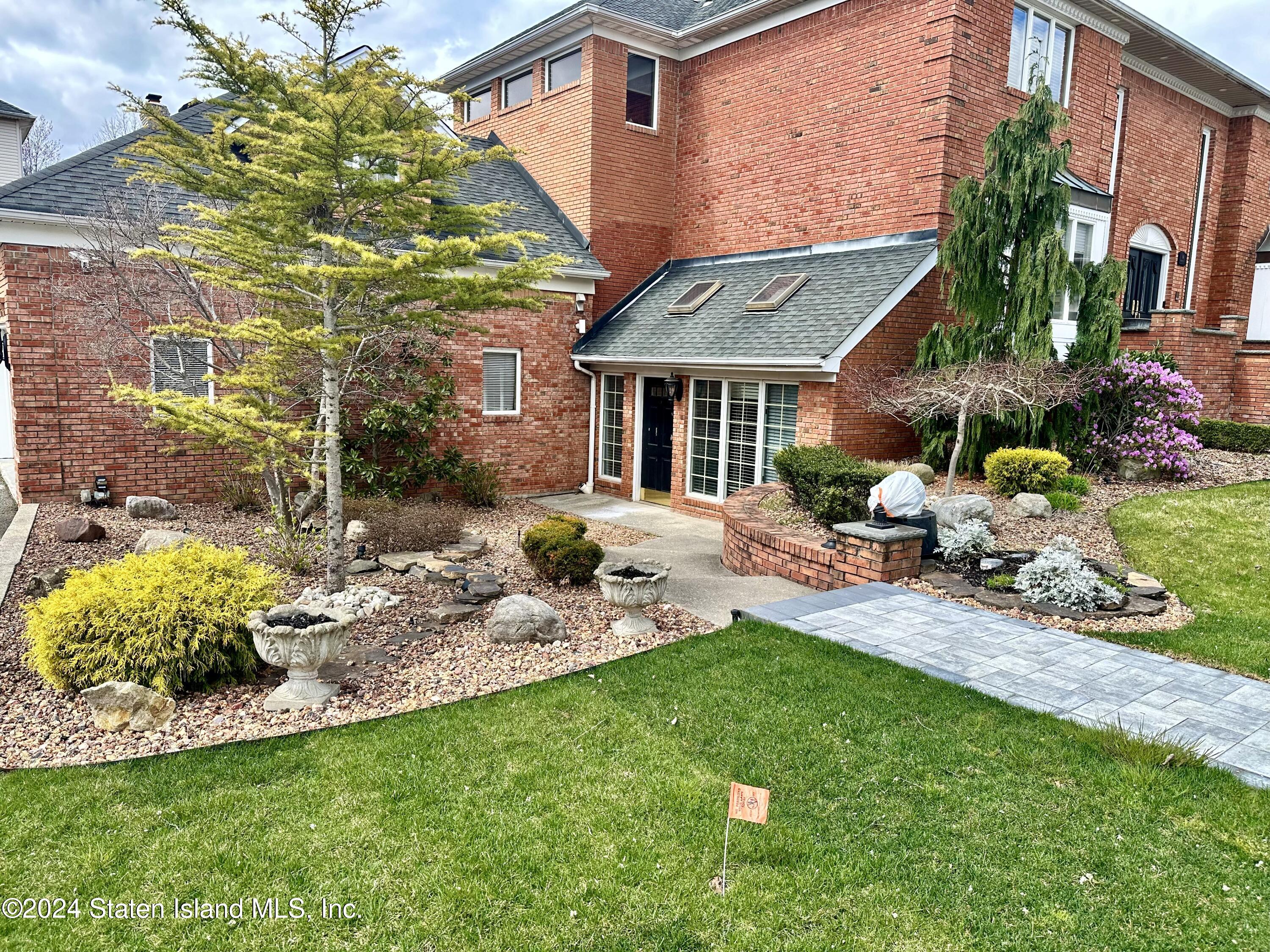 a view of a house with backyard sitting area and garden