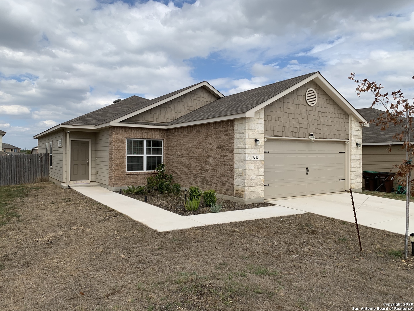 a view of a house with a yard and garage