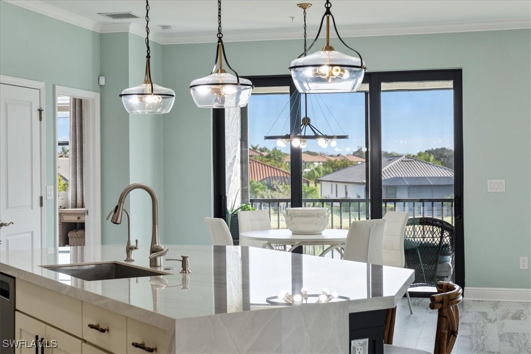 a room with chandelier fan and windows