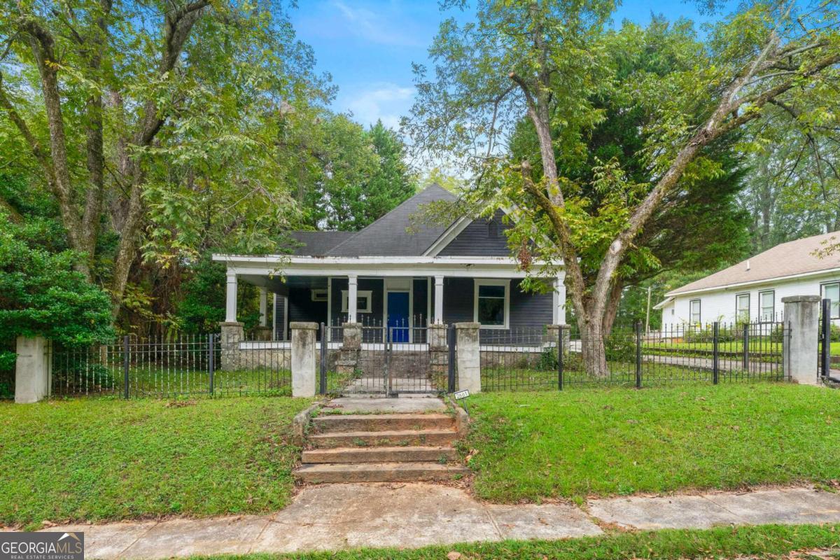 a front view of a house with a yard table and chairs