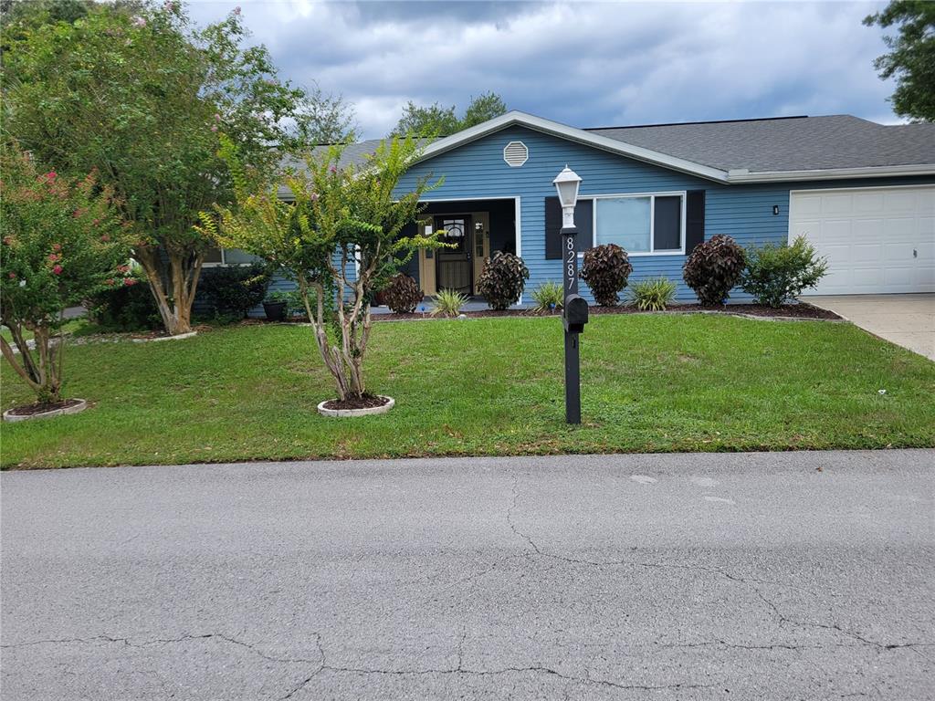 a front view of house with yard and green space