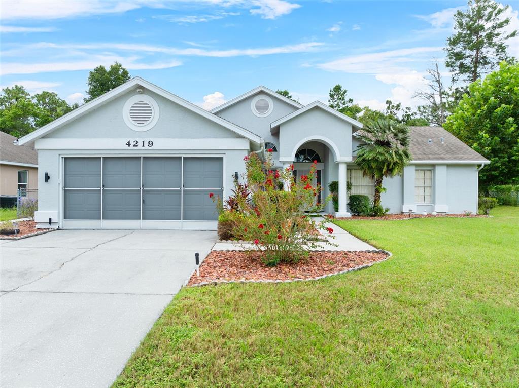 a front view of a house with a yard and garage