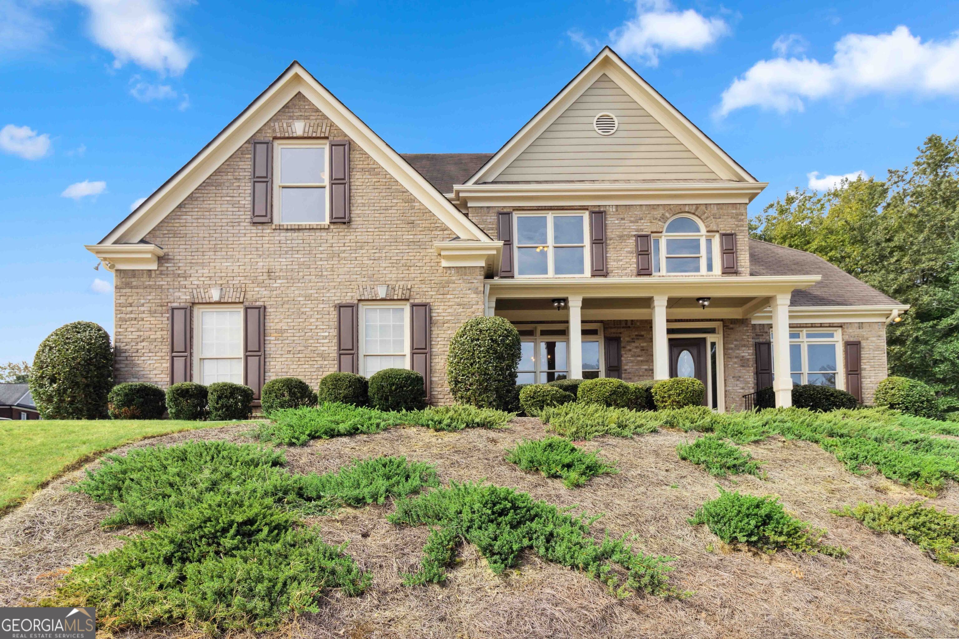 a front view of a house with a yard and garage