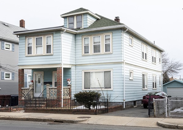 a front view of a house with parking