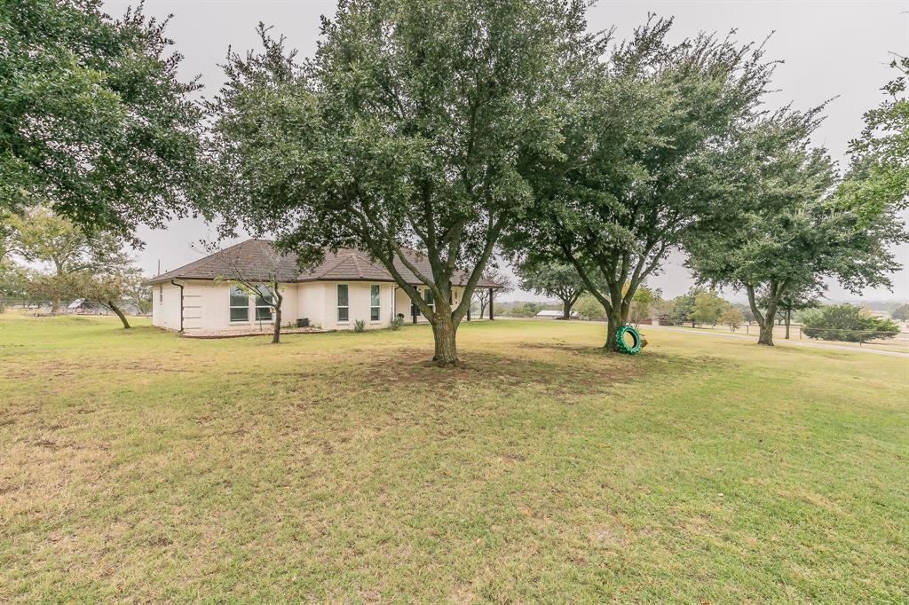 a view of house with trees in front of it