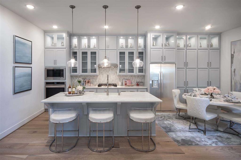 a large kitchen with a table and chairs