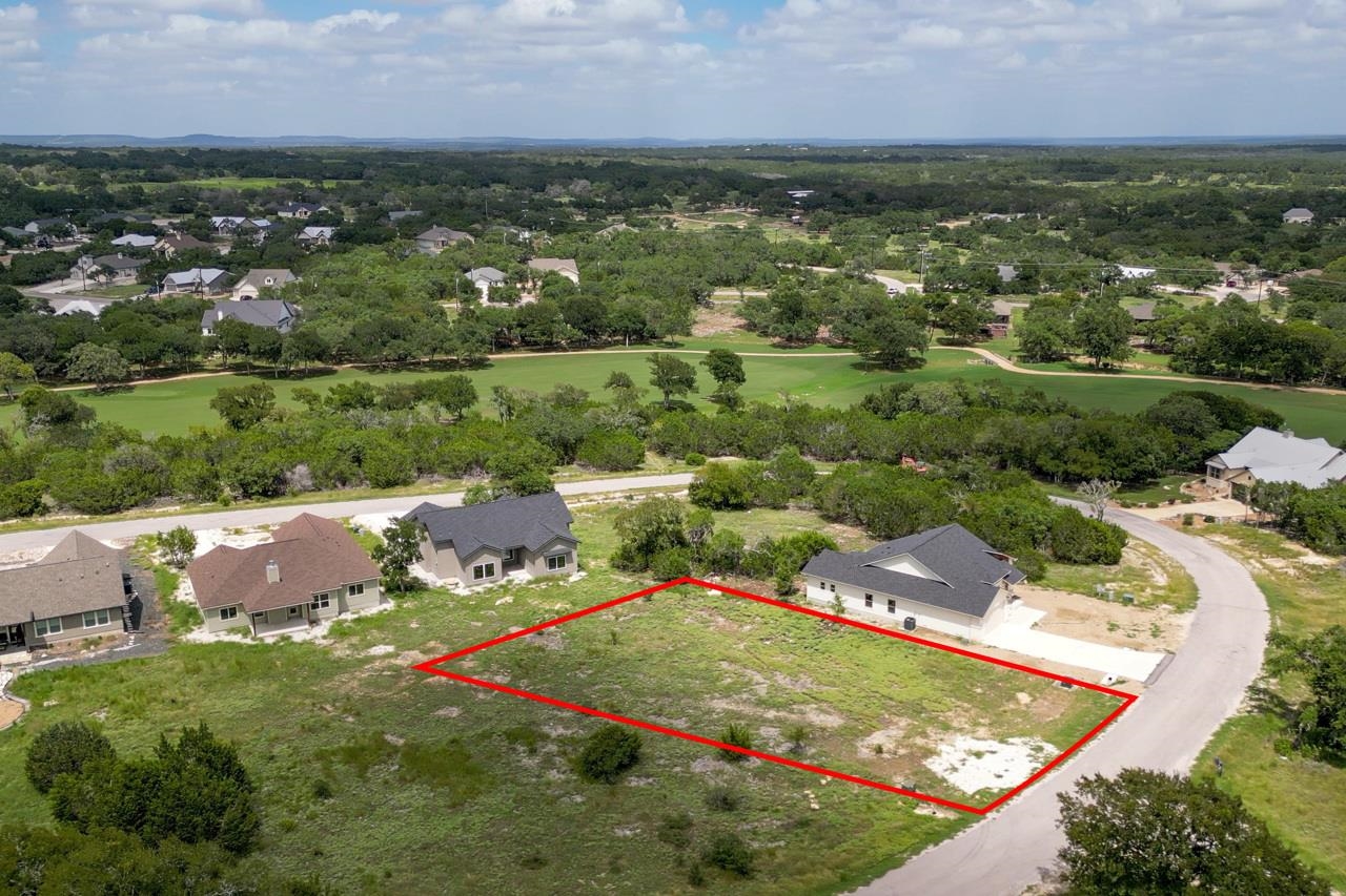 an aerial view of residential houses with outdoor space and river