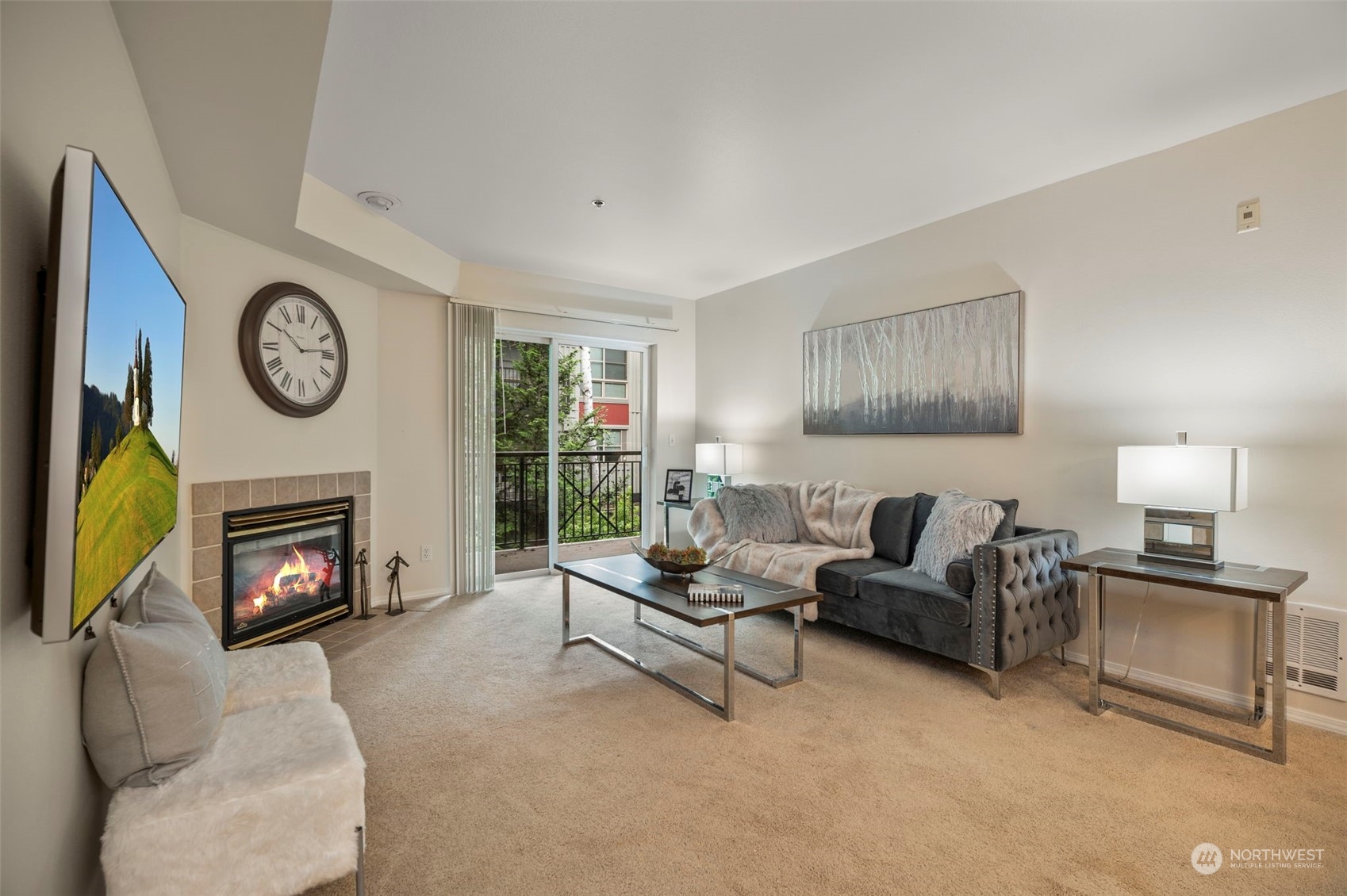 a living room with furniture a clock and a fireplace