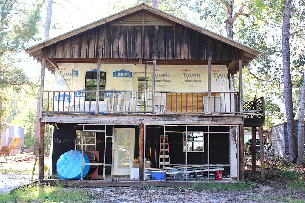 a view of a house with a yard and sitting area