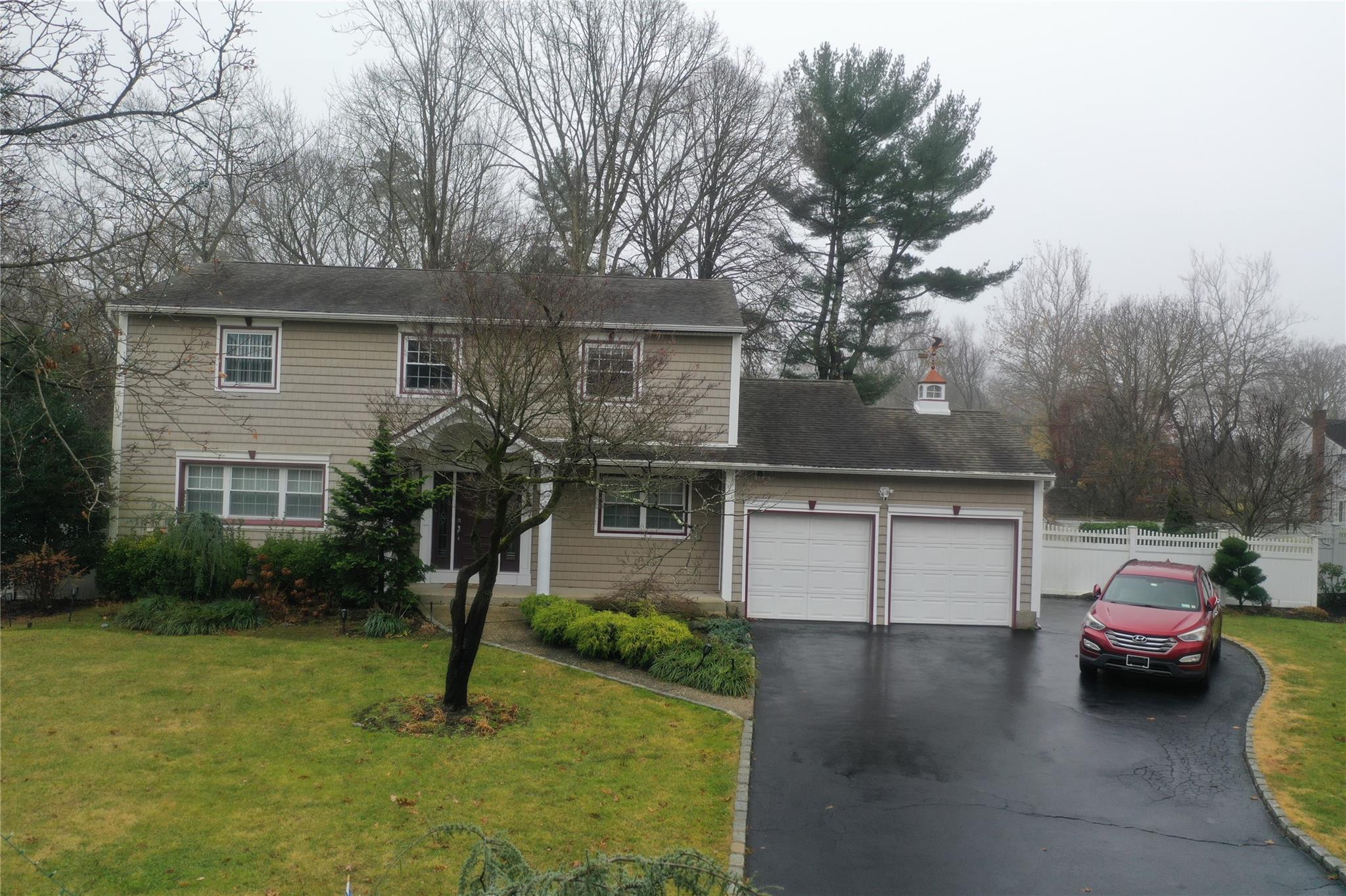 Front facade featuring a garage and a front yard