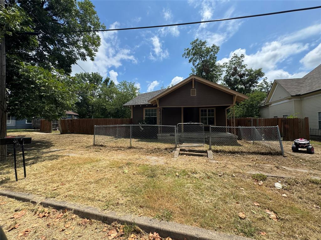 a backyard of a house with table and chairs