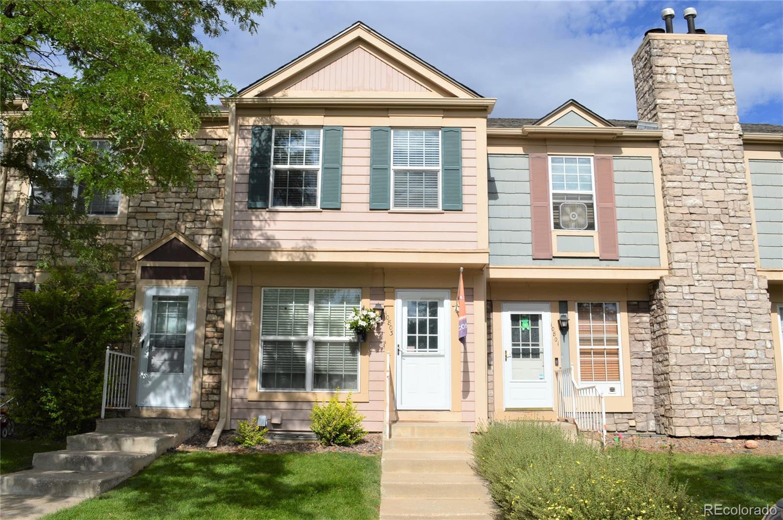 front view of a brick house with a yard