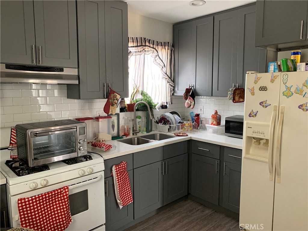 a kitchen with a sink a stove and cabinets