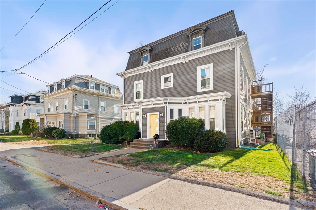 a front view of a residential houses with yard