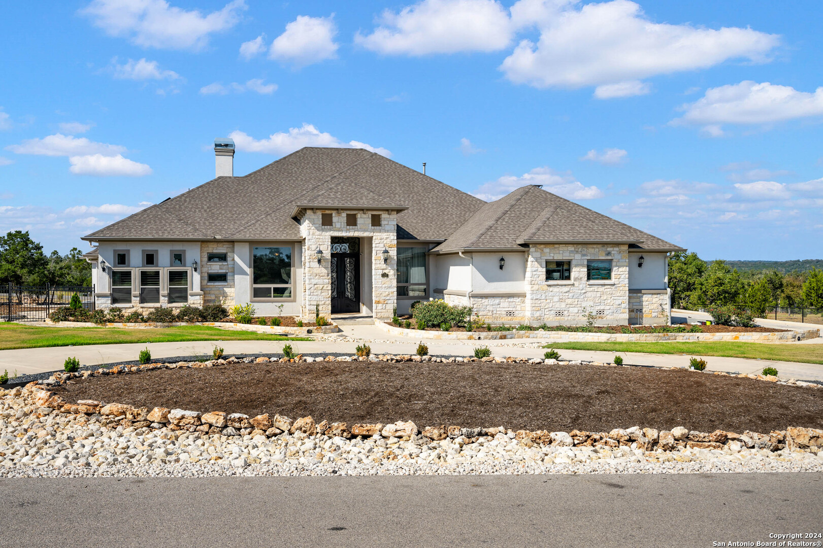 a front view of a house with garden