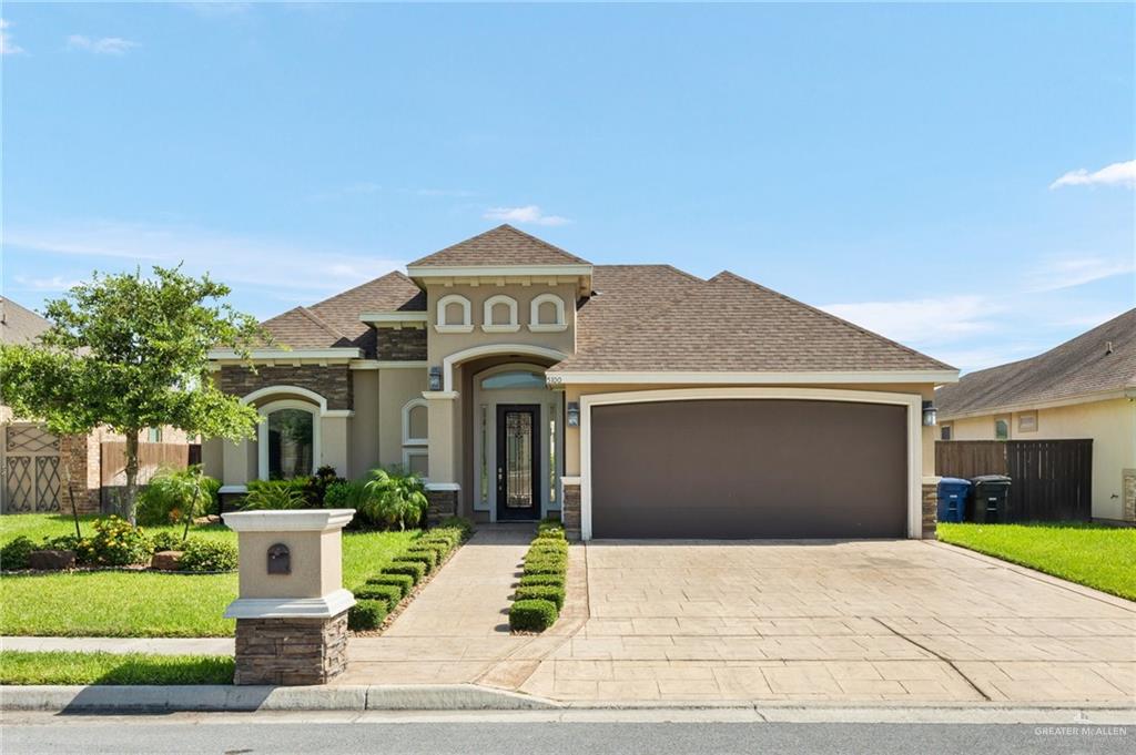 a front view of a house with a yard and garage