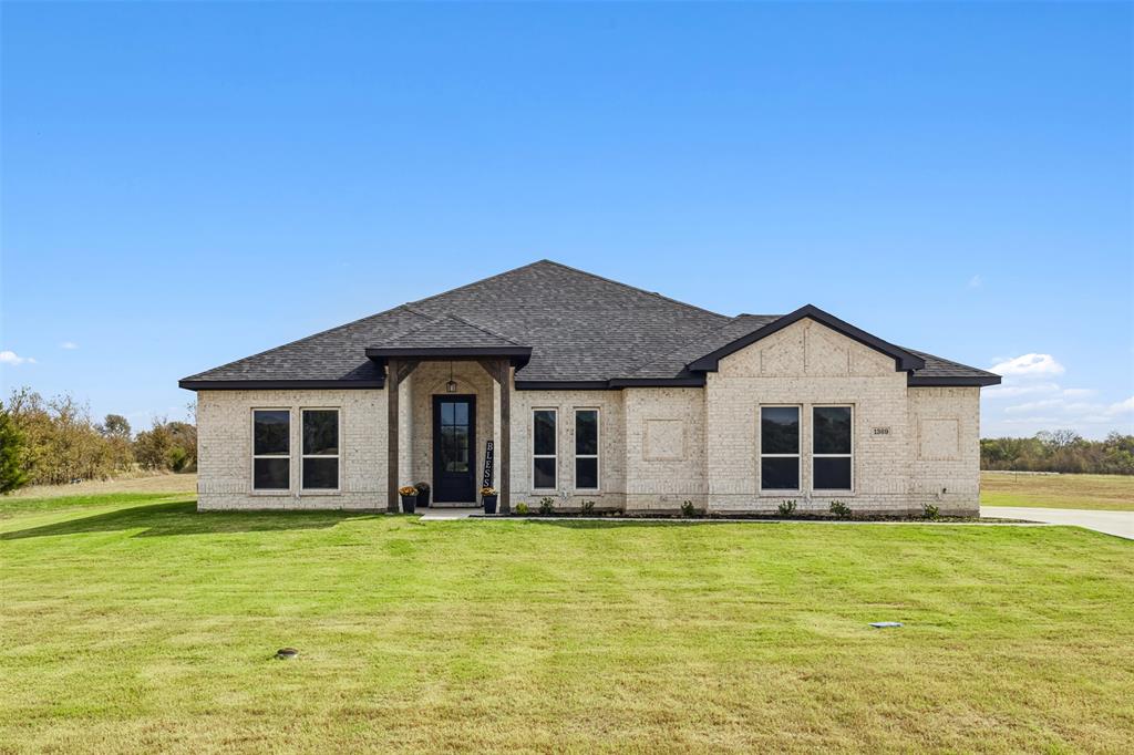 a front view of a house with a yard