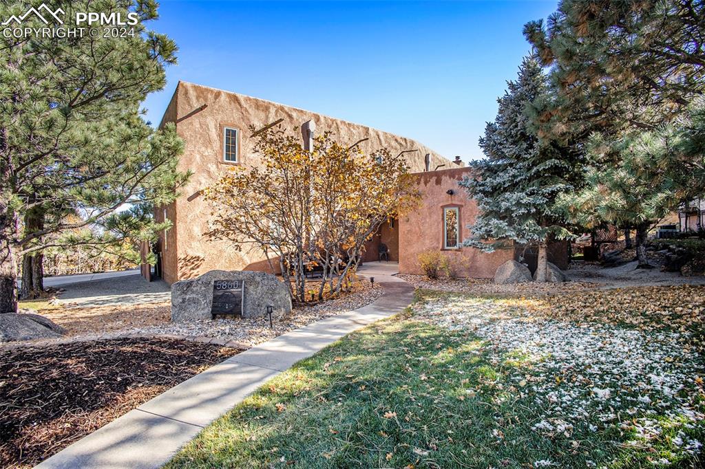 Southwest-style home featuring a front lawn