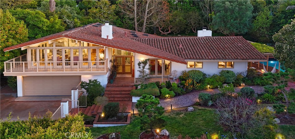 Hidden private oasis on 20,000 SF lot surrounded by lush landscaping.