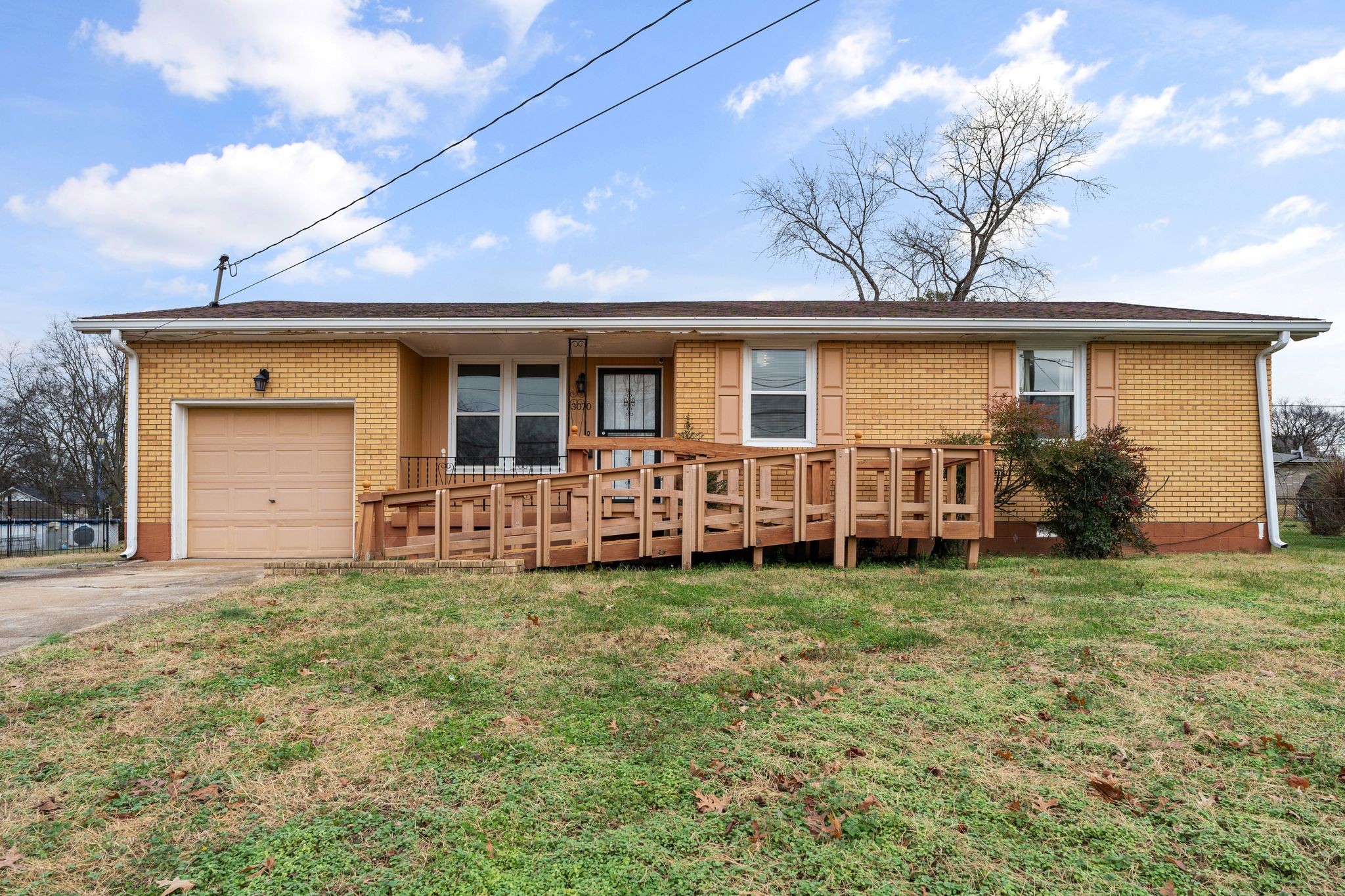 a view of a house with backyard and a tree