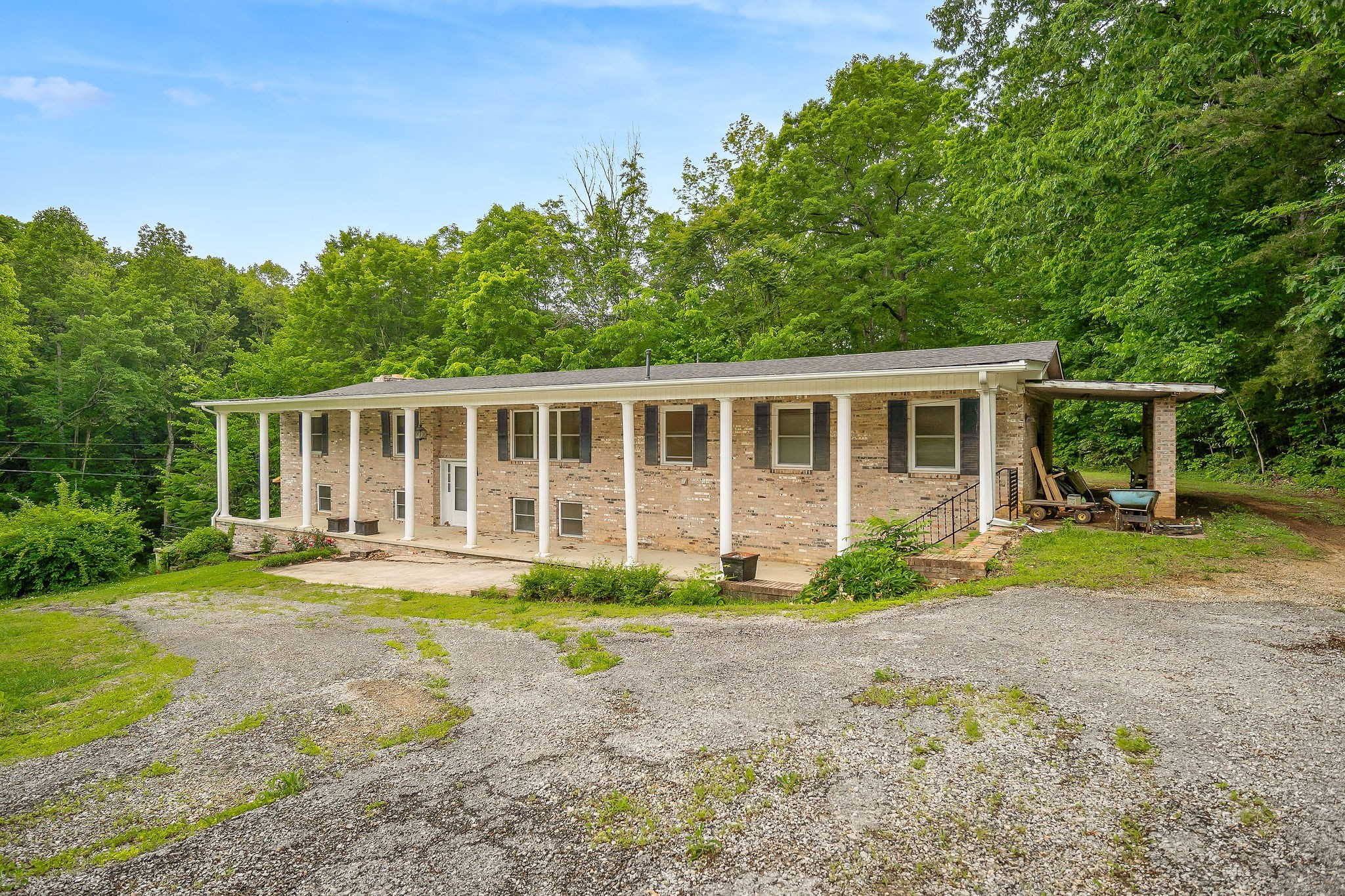 a front view of a house with a yard and porch