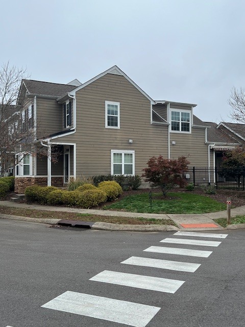 a front view of a house with a garden