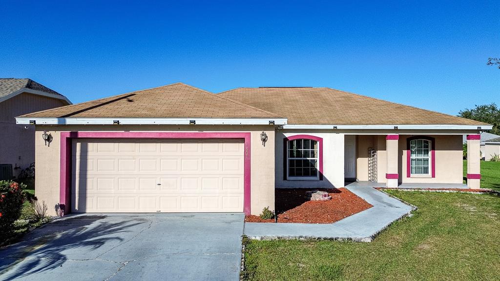 a front view of a house with a yard and garage