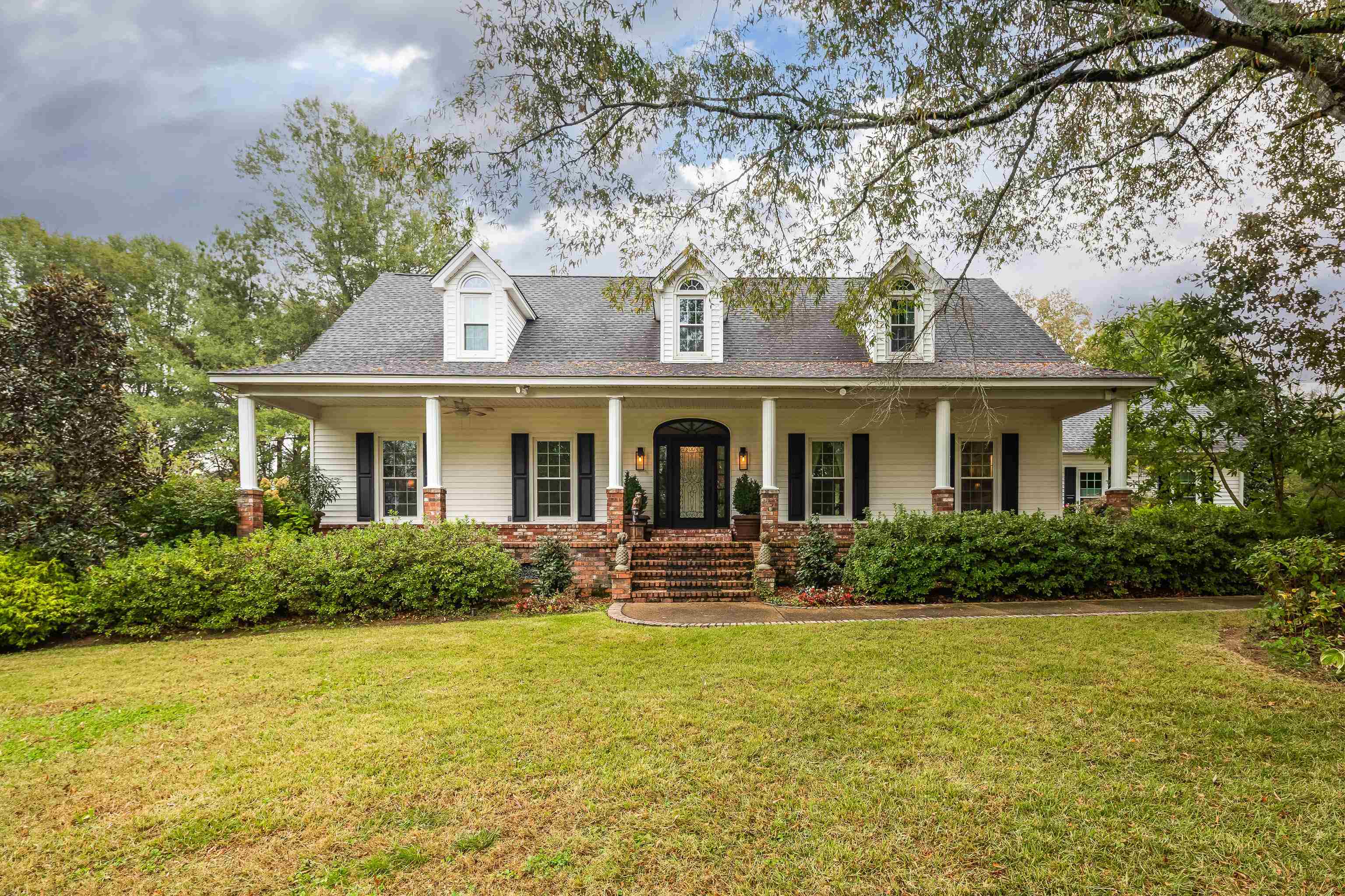 a front view of a house with garden