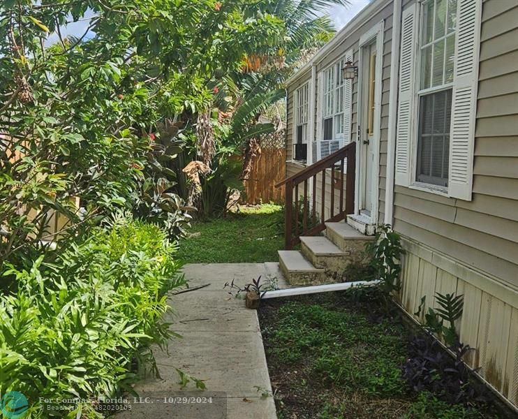 a view of house with garden and deck