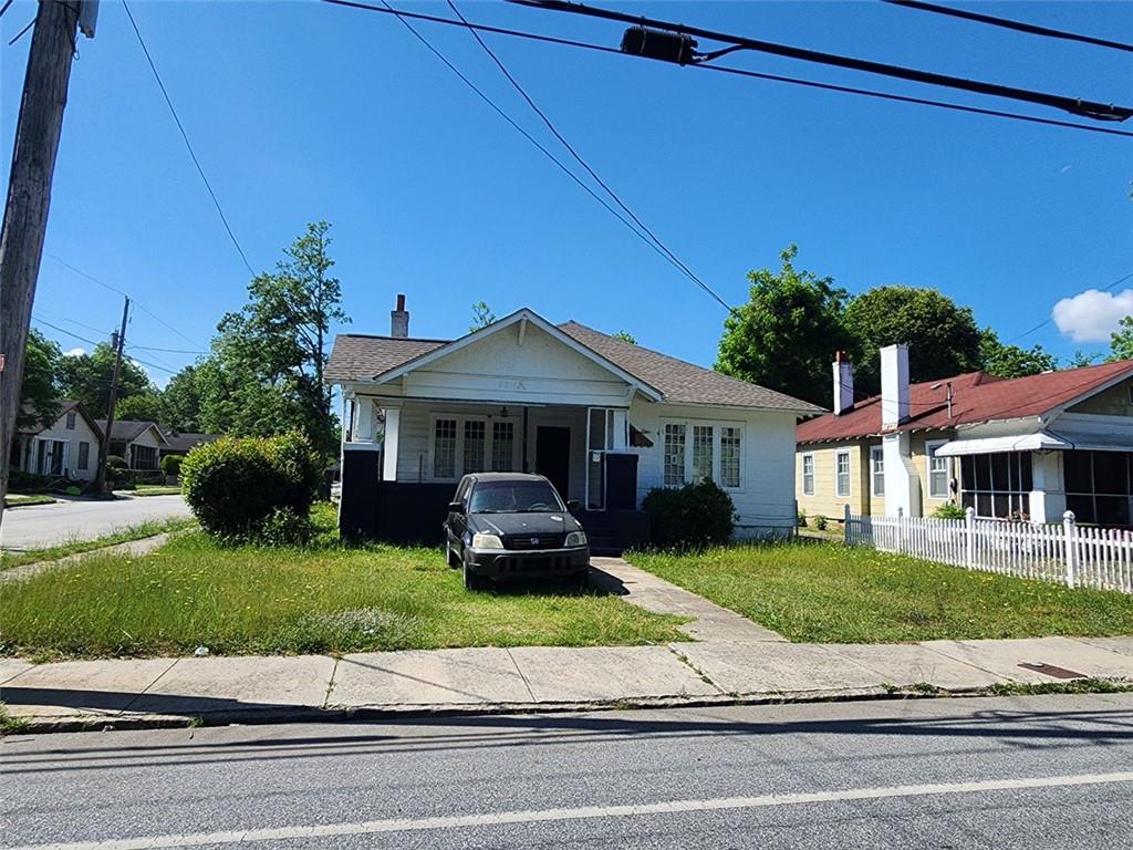 a front view of a house with a garden and yard