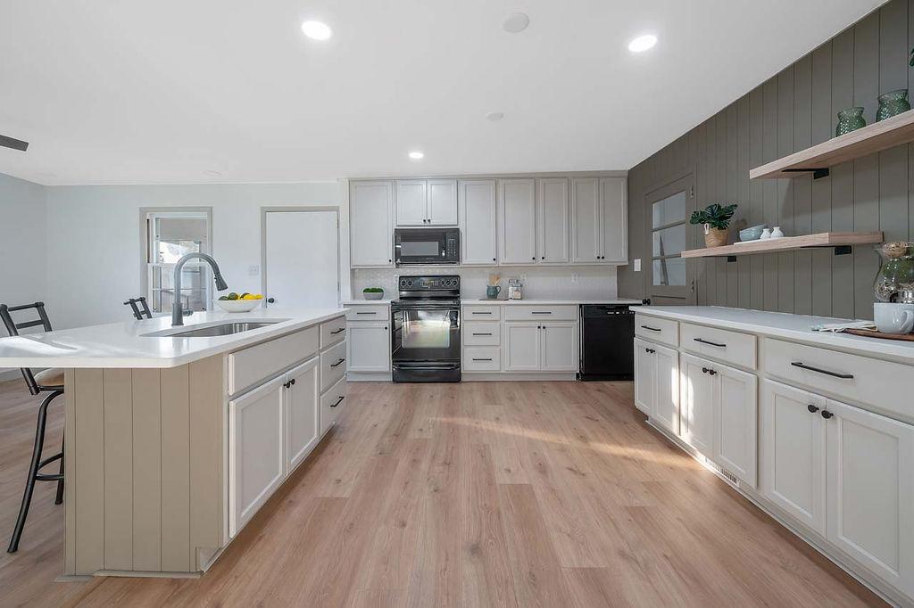 a kitchen with sink stove and cabinets