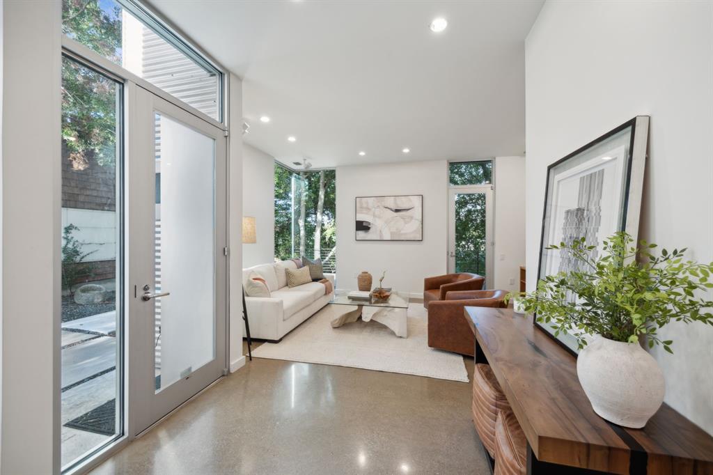 a living room with furniture and a potted plant