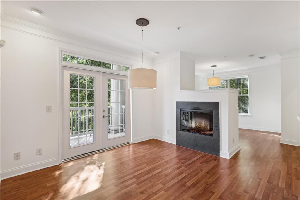 a view of an empty room with a fireplace and a window