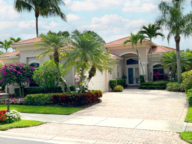 a front view of multiple houses with palm trees