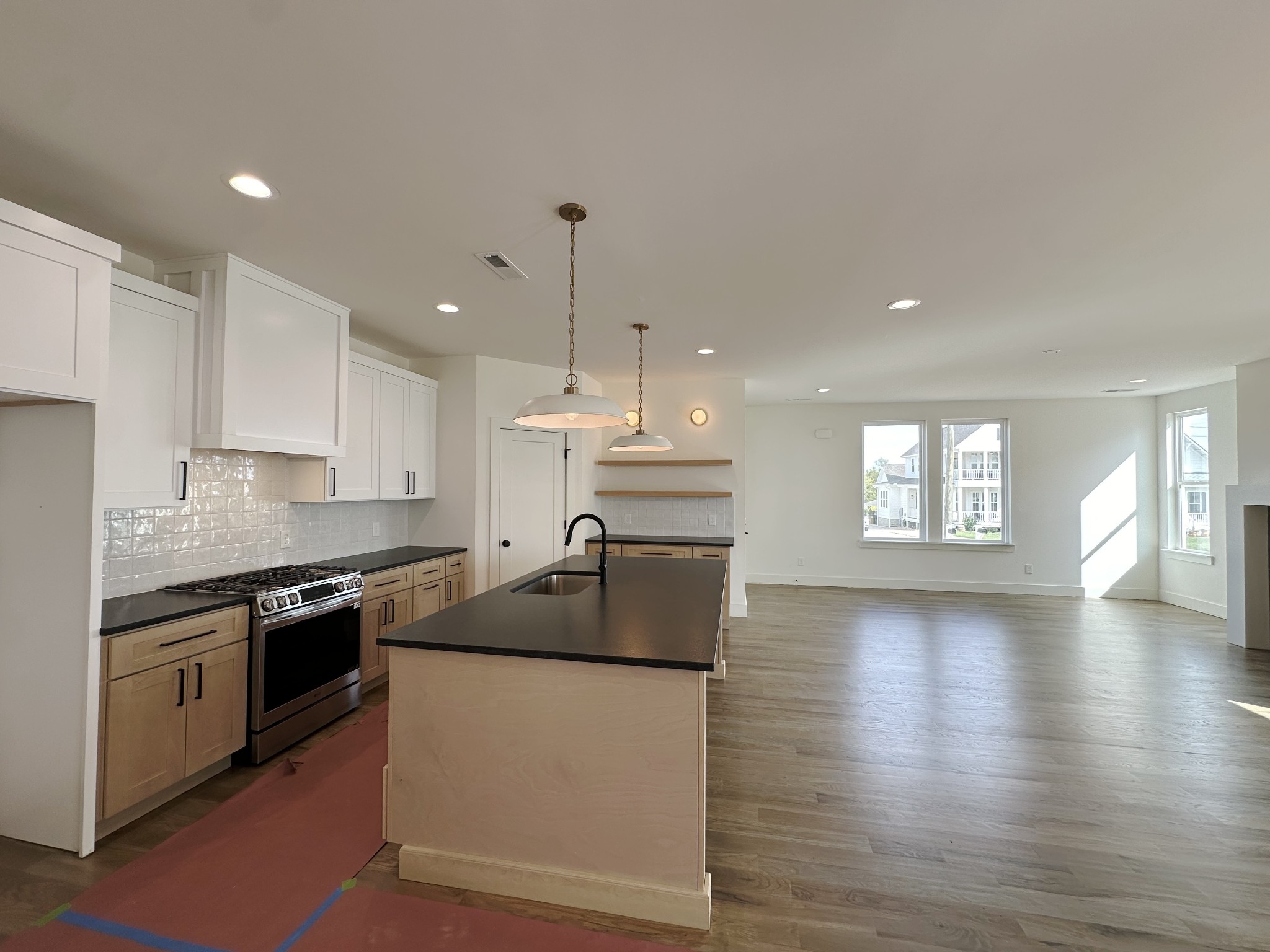 a kitchen with stainless steel appliances granite countertop a stove sink and cabinets