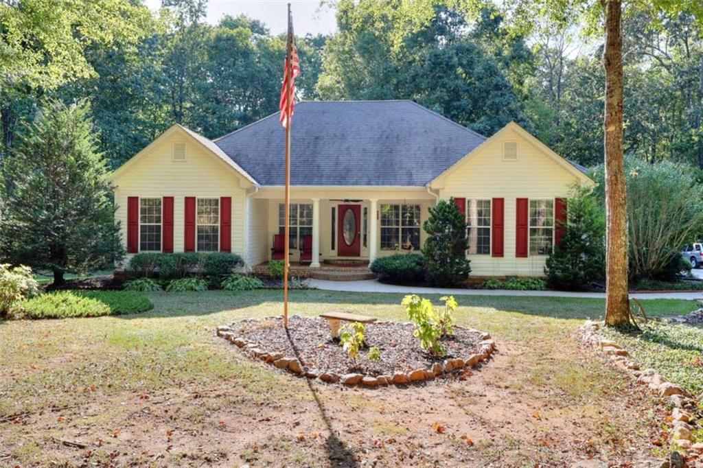 a front view of a house with a yard and porch