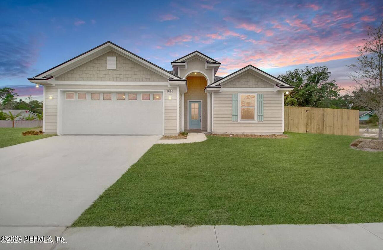 a front view of a house with a yard and garage