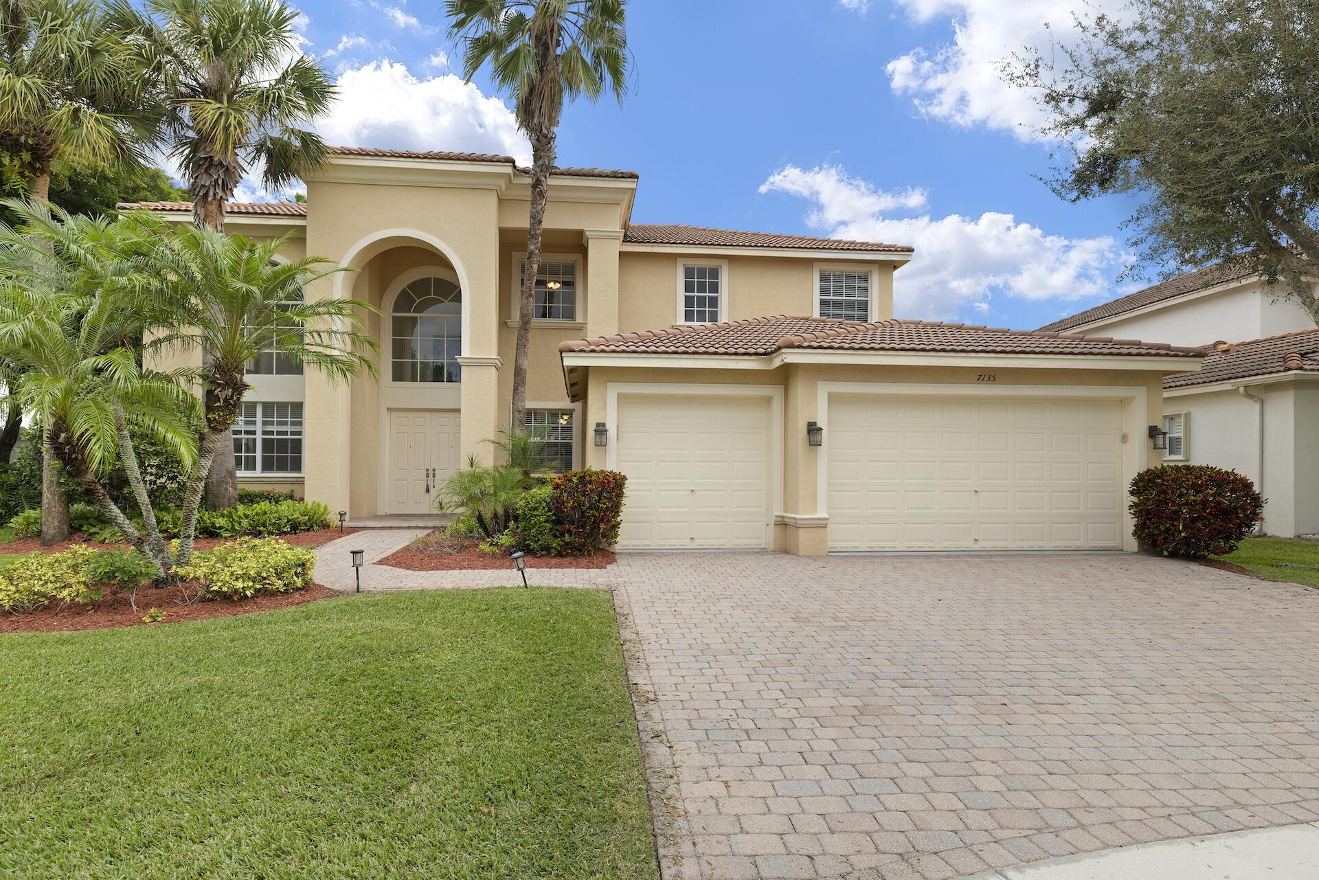 a view of a house with a yard and garage