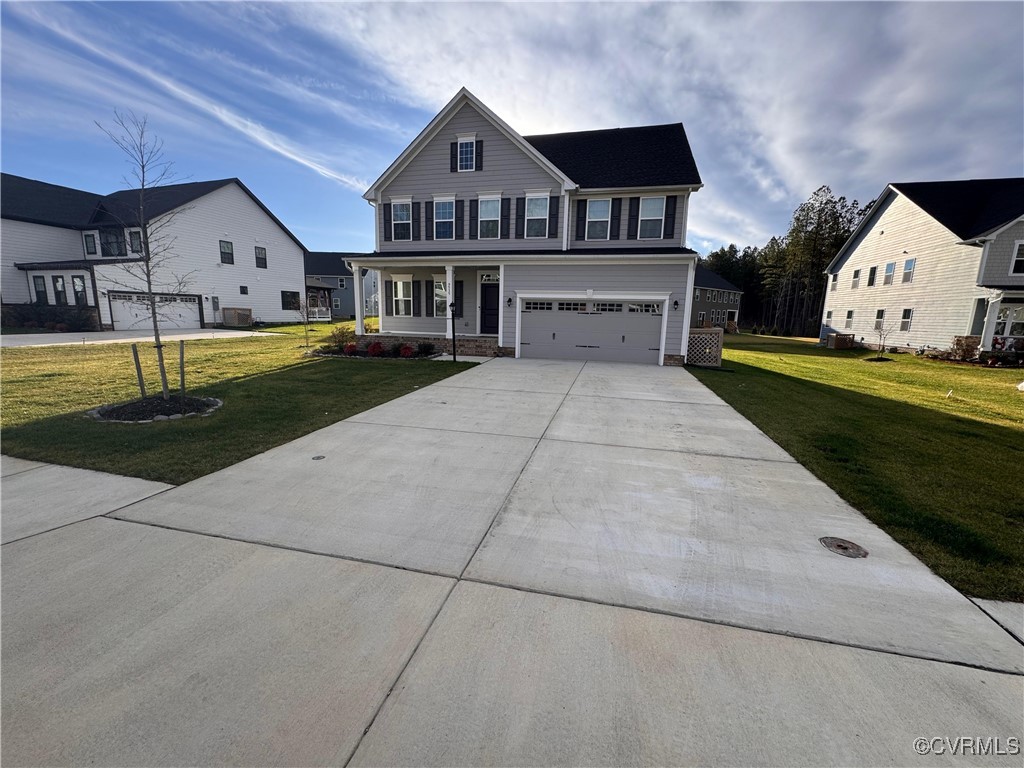 View of front of home featuring covered porch, a f