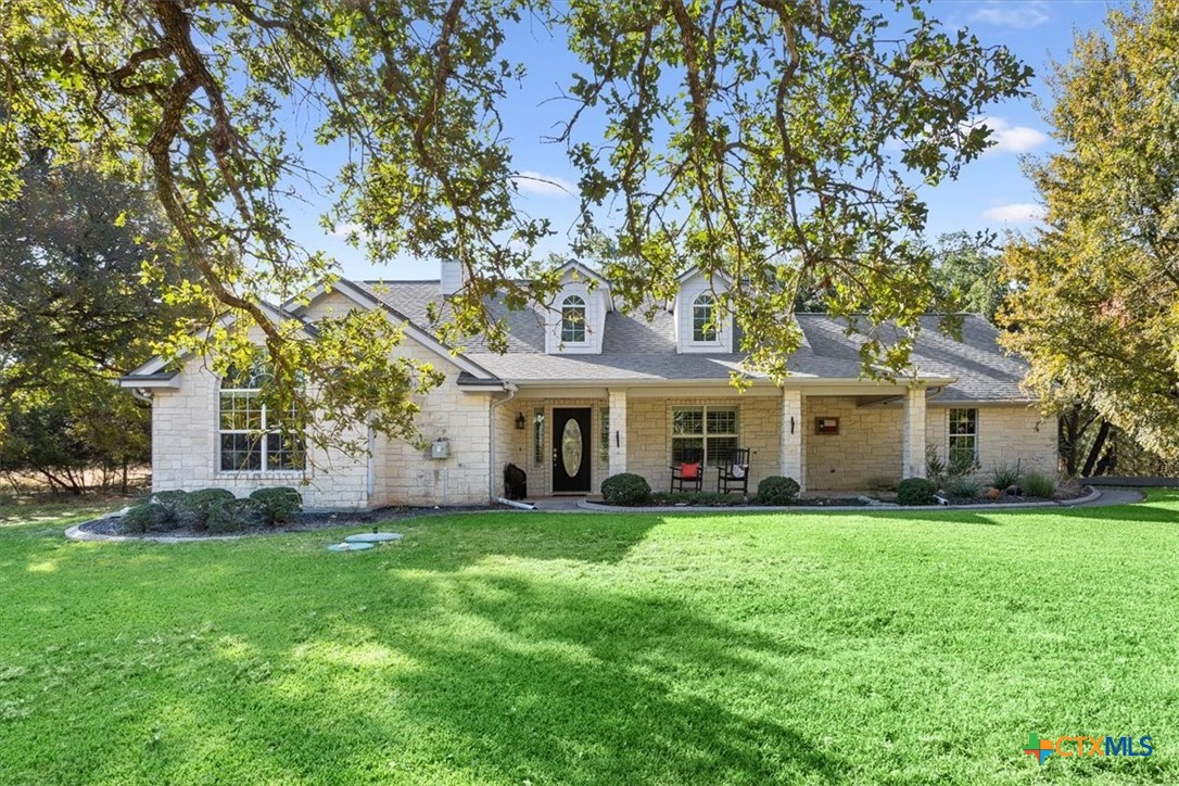 a large house with a big yard and large trees