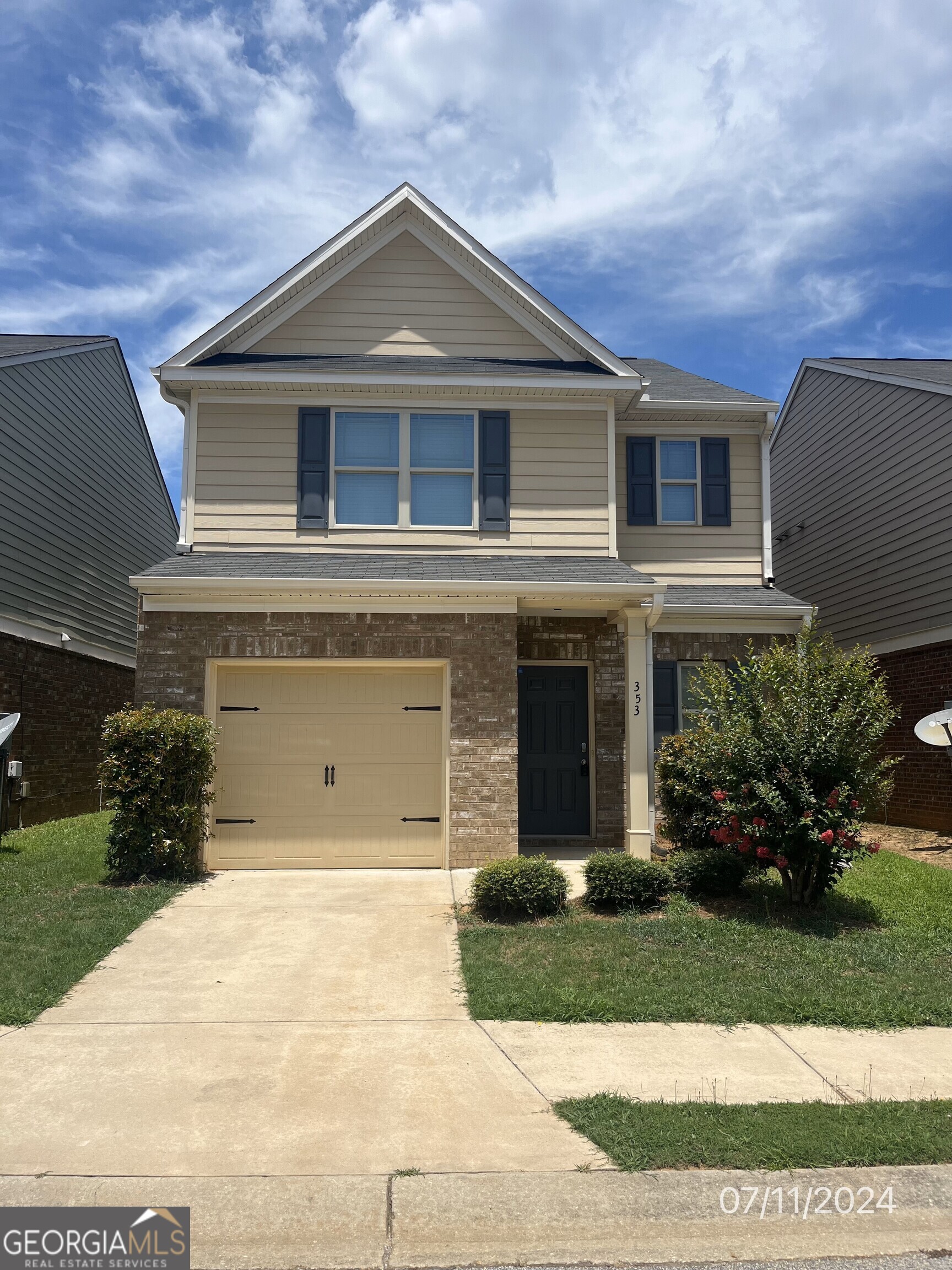 a front view of a house with a yard and garage