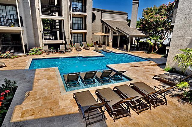 a view of a patio with table and chairs with wooden floor and fence