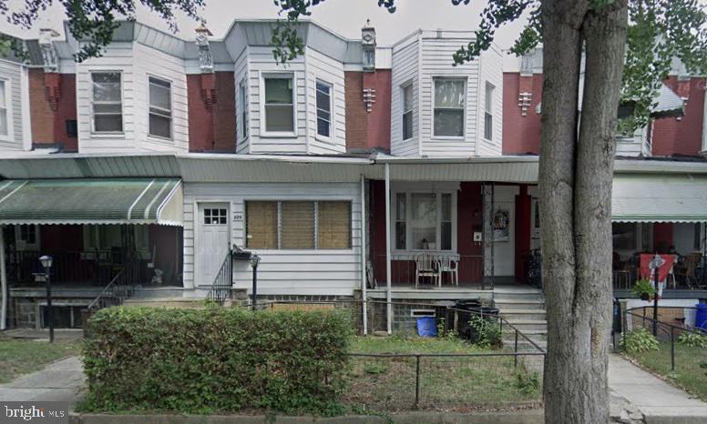 front view of a brick house with a yard