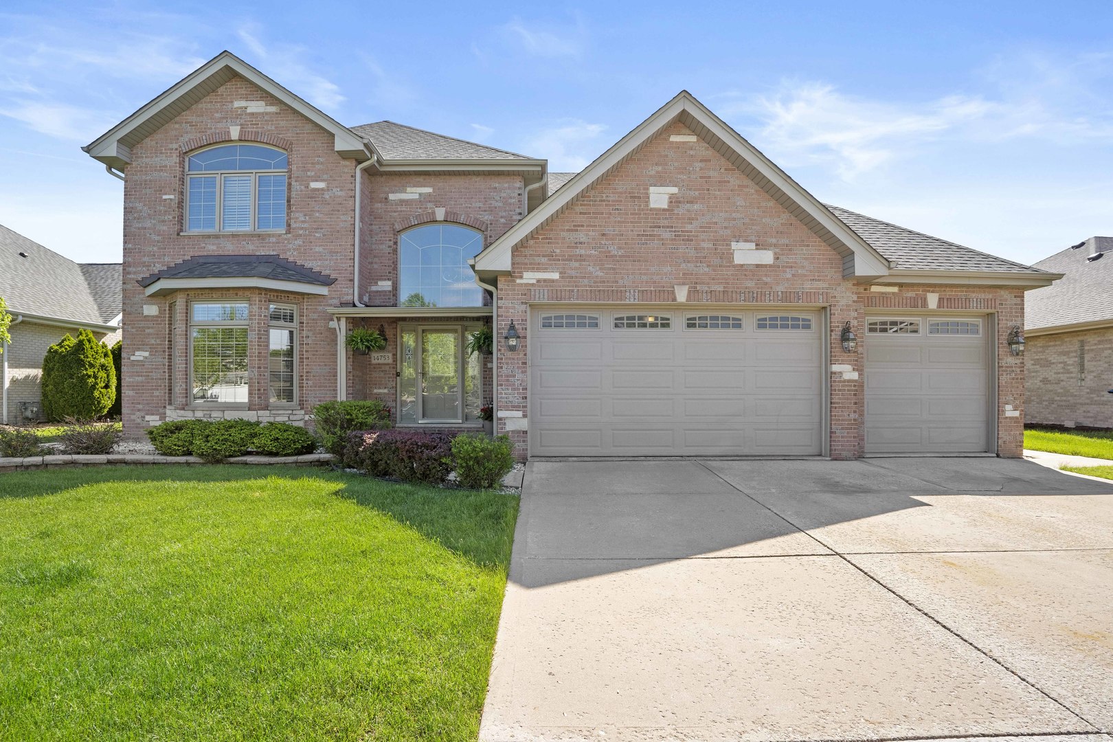 a front view of a house with a yard and garage