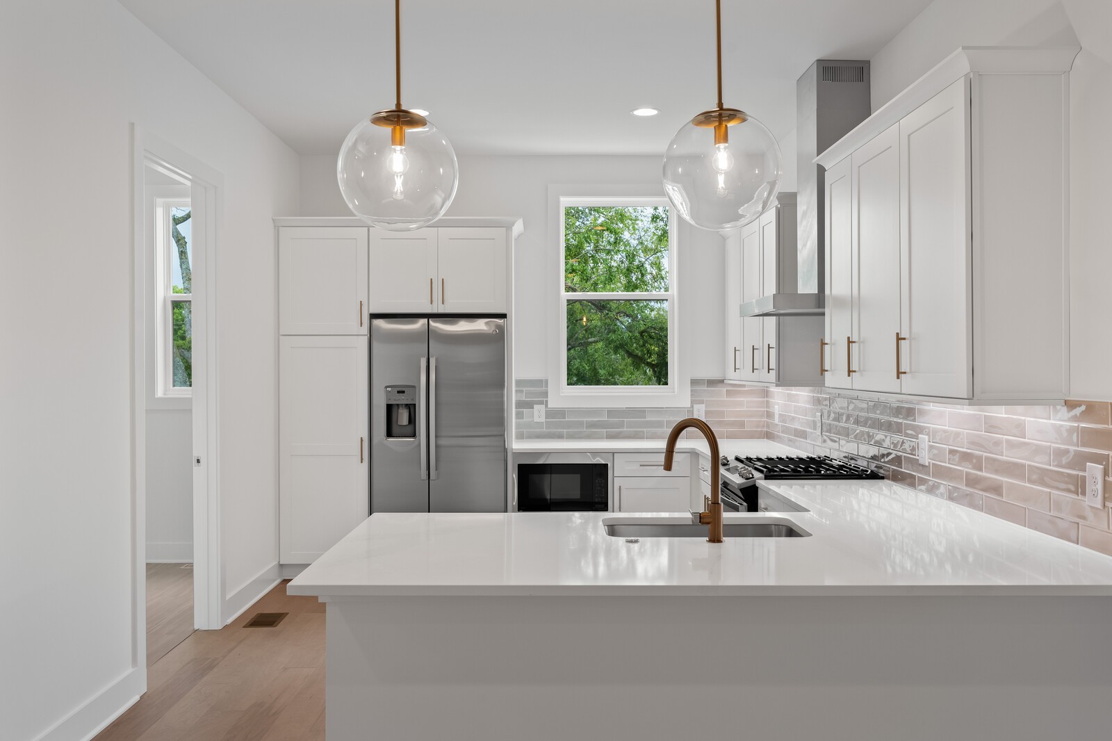 a kitchen with kitchen island a sink stainless steel appliances and window