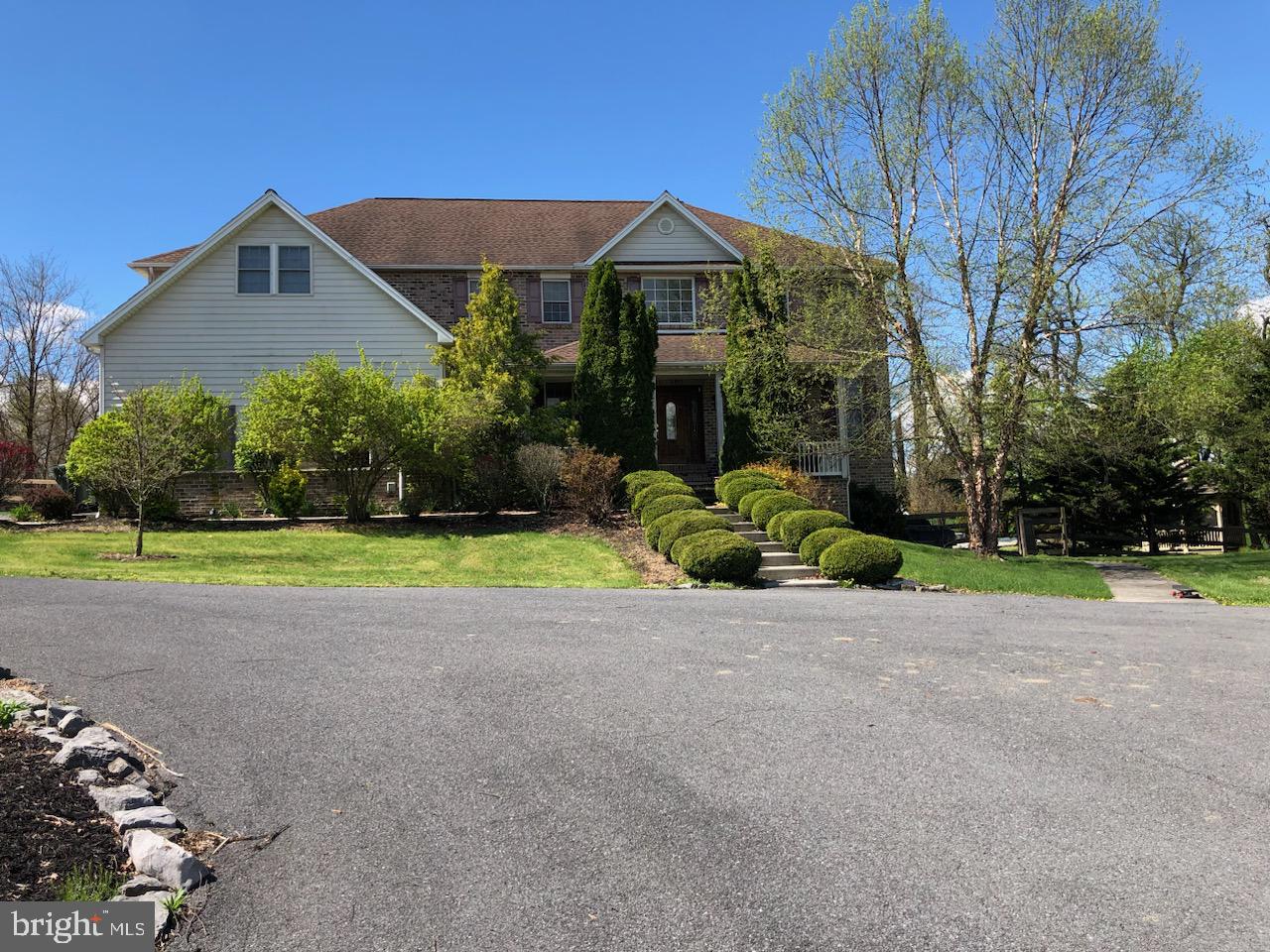 a view of a house with a yard and potted plants